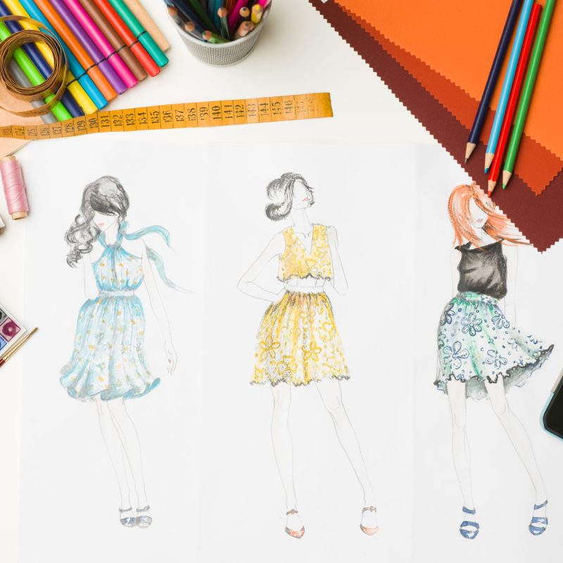 fashion designer workspace top view of desk with fashion designing equipment and sketches